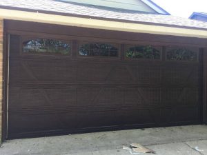 wooden two car garage door with windows